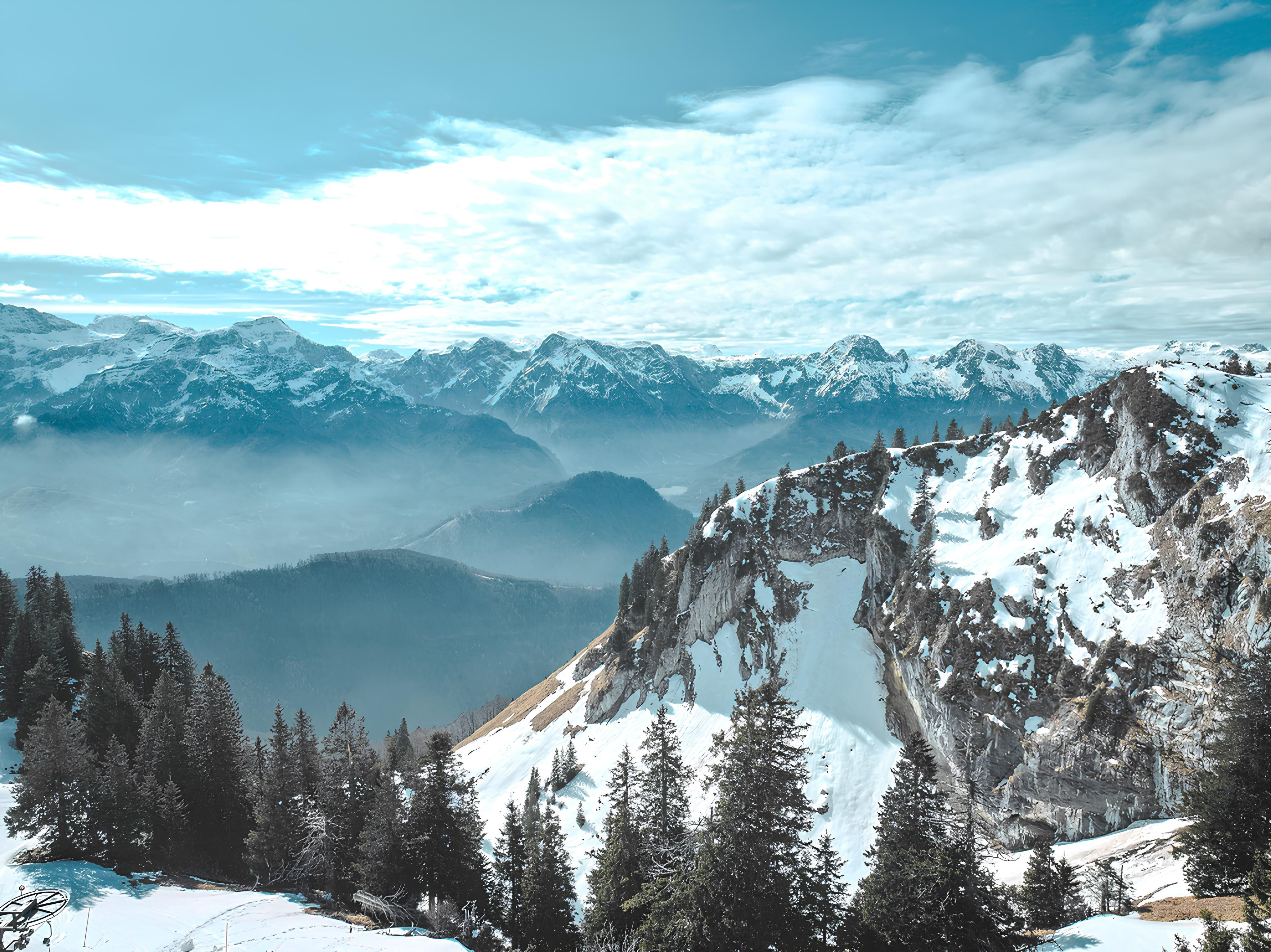 Snow-covered Alpine peaks in Hinterstoder, Austria, offering a dramatic winter vacation setting.