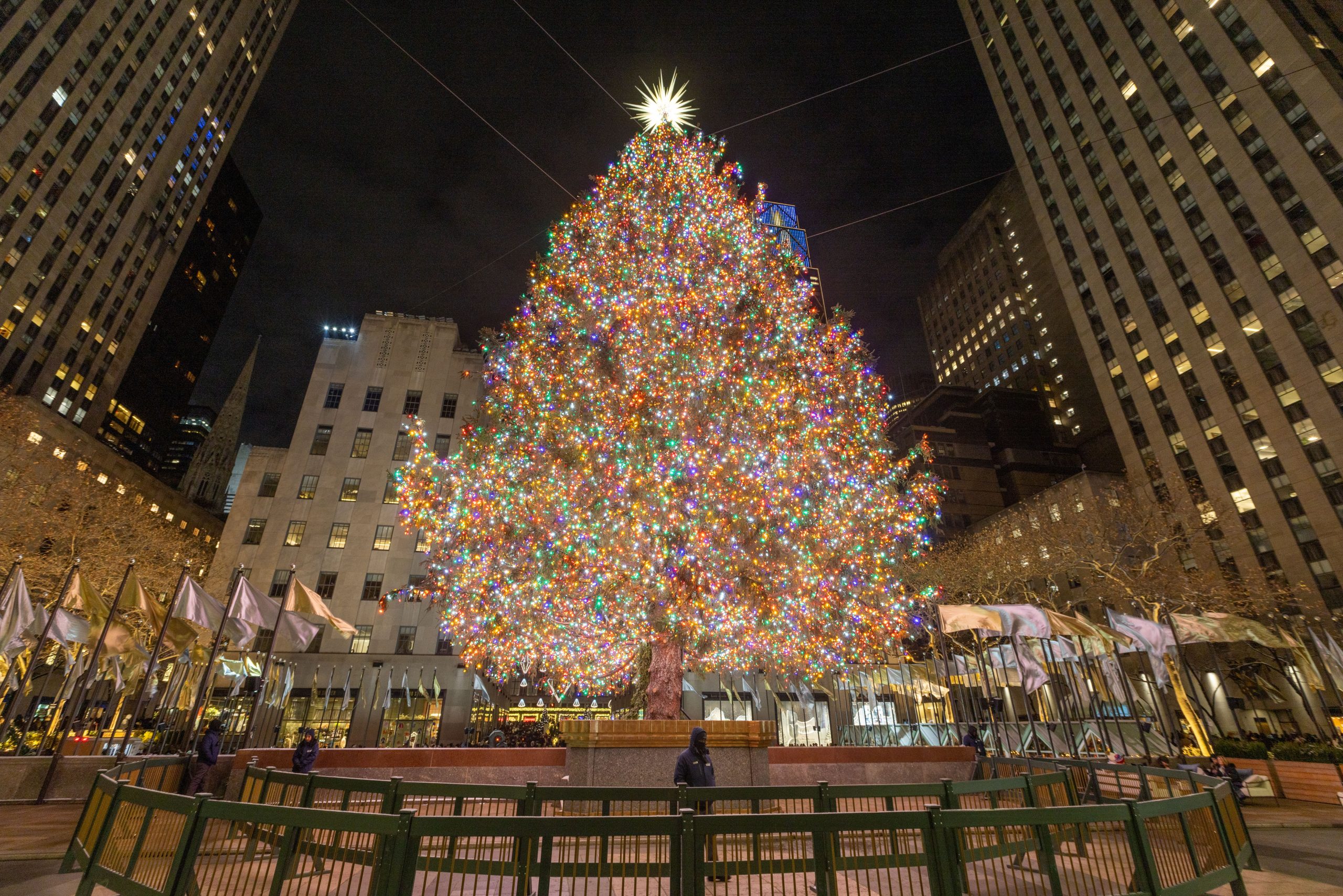 Rockefeller Center Christmas tree glowing at night in New York City, a festive December travel destination.