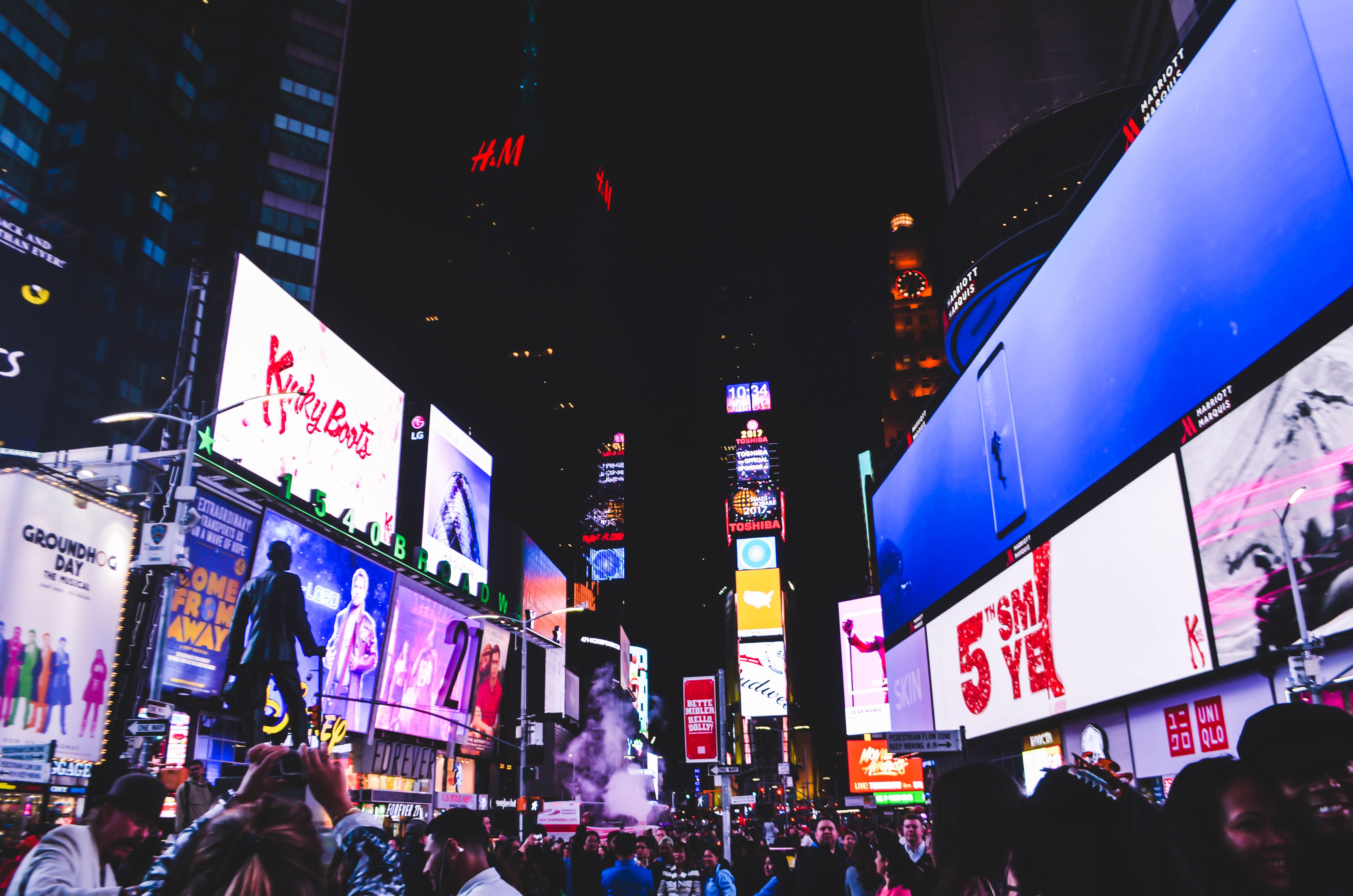 Times Square in New York City glows with digital billboards and crowds at night.